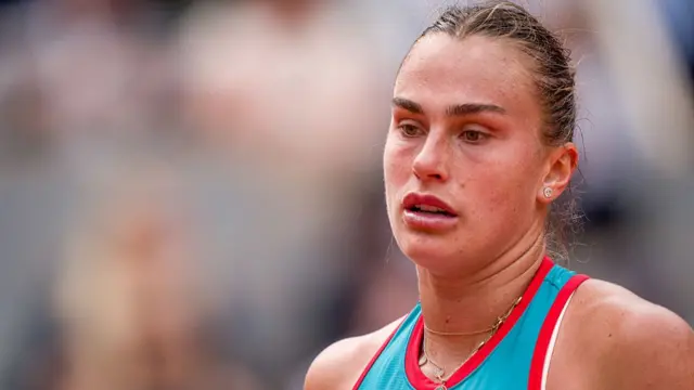 Aryna Sabalenka looks on