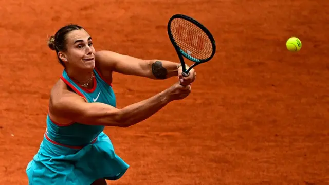 Aryna Sabalenka plays a backhand return