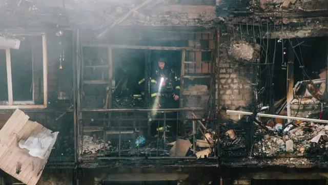 A firefighter in a building in Kharkiv