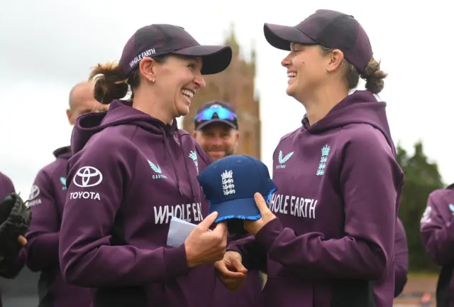Amy Jones is presented her 100th ODI by Kate Cross