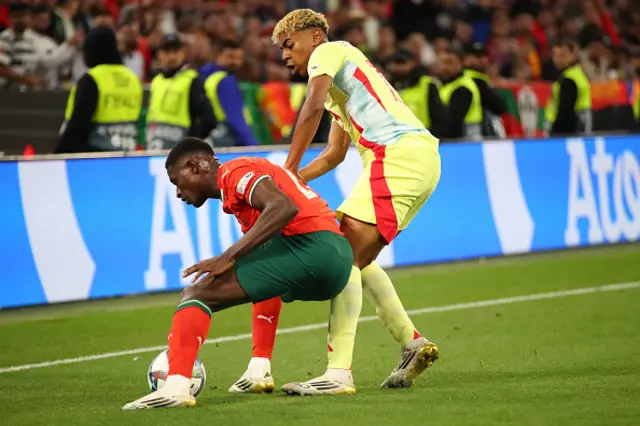 Nuno Mendes of Portugal and Lamine Yamal of Spain in action