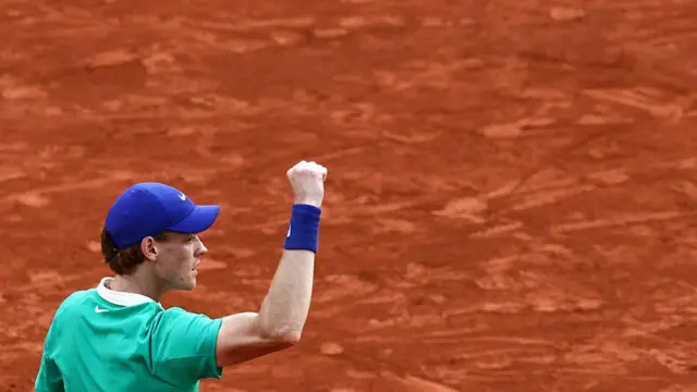 Jannik Sinner reacts after winning a game