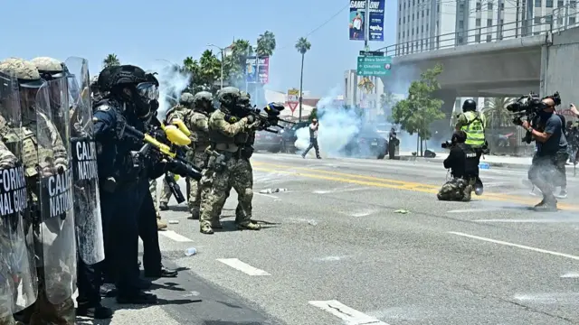 National Guard soldiers and US Department of Homeland Security (DHS) Police officers clash with demonstrators outside the Metropolitan Detention Center, MDC, in downtown Los Angeles