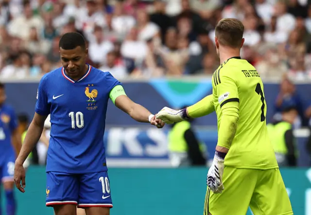 Kylian Mbappe (L) interacts with Germany's goalkeeper #01 Marc-Andre Ter Stegen