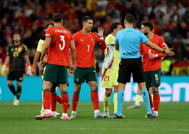 Cristiano Ronaldo of Portugal interacts with match referee Sandro Scharer