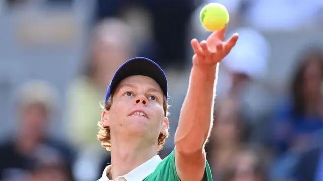 Jannik Sinner serves