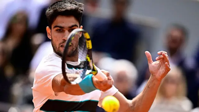 Carlos Alcaraz plays a forehand return