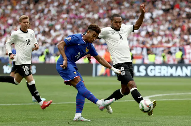 Jonathan Tah (R) and France's forward #24 Desire Doue (C) vie for the ball