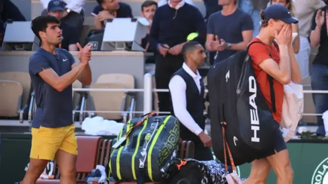 Carlos Alcaraz applauds the crowd after beating Jannik Sinner at last year's French Open