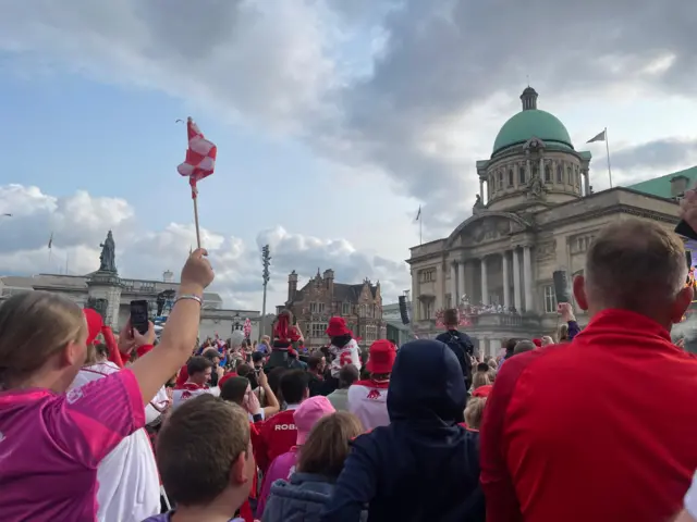 Fans shout and cheer towards the balcony at Hull City Hall