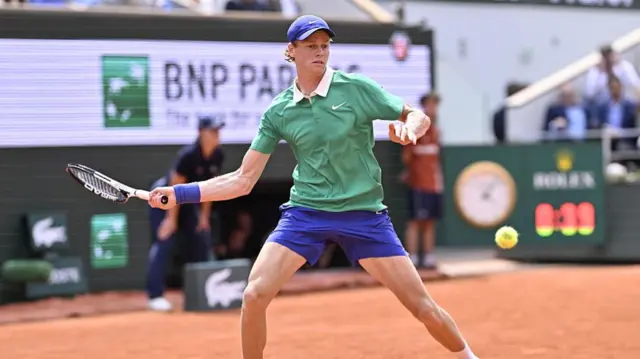 Jannik Sinner plays a forehand