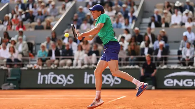 Jannik Sinner plays a backhand