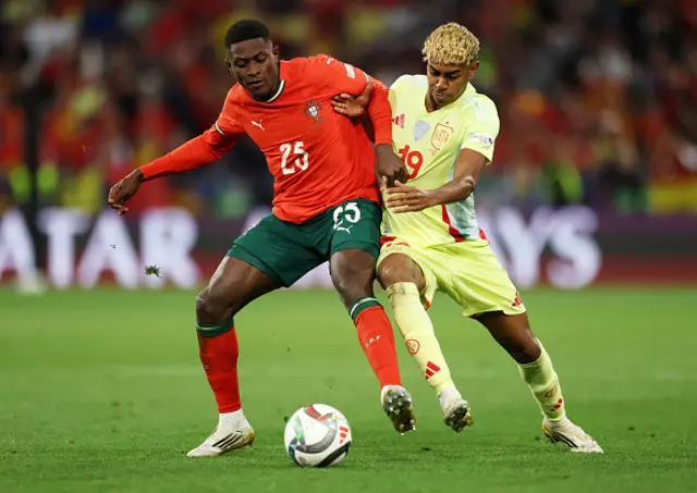 Nuno Mendes of Portugal battles for possession with Lamine Yamal
