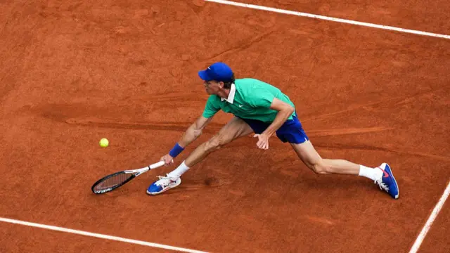 Jannik Sinner plays a backhand