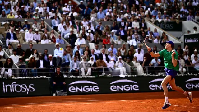 Jannik Sinner plays a forehand return