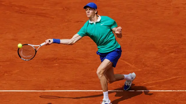 Jannik Sinner hits a forehand