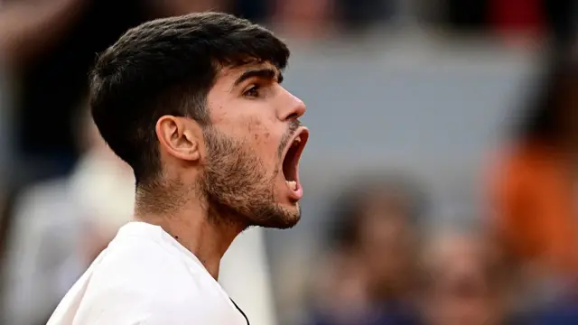 Carlos Alcaraz reacts after winning the fourth set