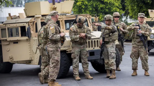 Members of National Guard wait in LA