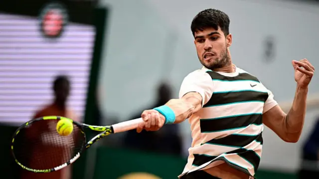 Carlos Alcaraz plays a forehand return
