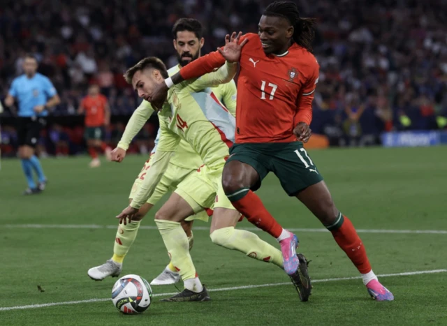 Spain's Oscar Mingueza in action with Portugal's Rafael Leao