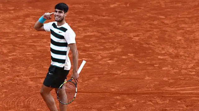 Carlos Alcaraz reacts after winning a point