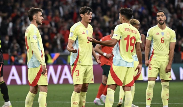 Spain's Robin Le Normand talks to Martin Zubimendi during the match