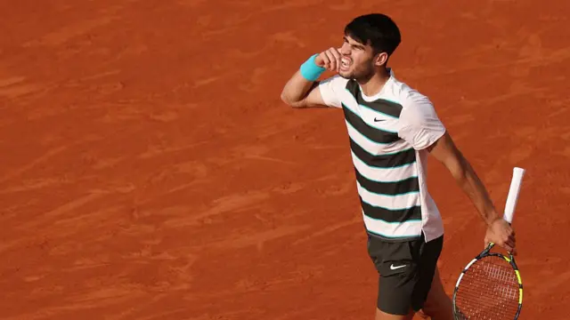 Carlos Alcaraz gestures as he plays
