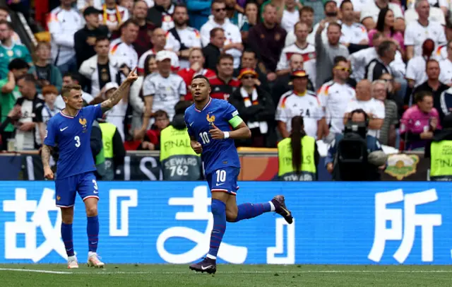 Kylian Mbappe (R) celebrates