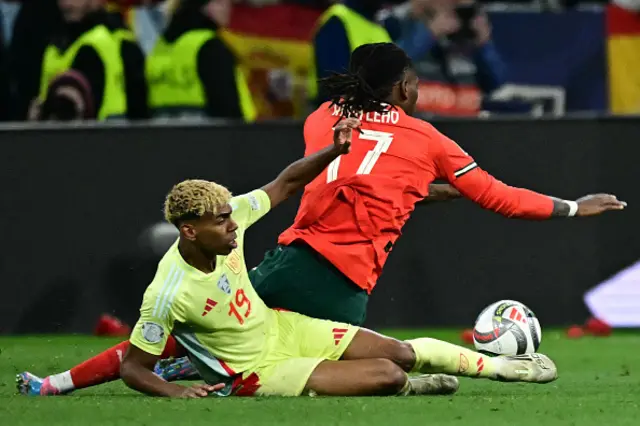 Lamine Yamal (L) and Portugal's forward #17 Rafael Leao vie for the ball