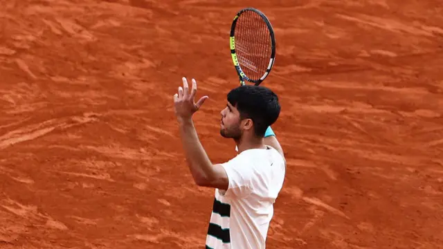 Carlos Alcaraz reacts after winning a point
