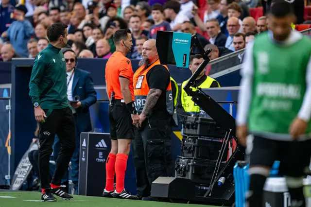 Referee Ivan Kruzliak views the VAR monitor