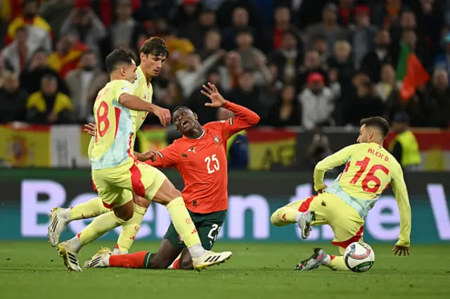 Nuno Mendes of Portugal is challenged by Alex Baena