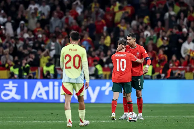 Cristiano Ronaldo of Portugal (R) speaks to Bernardo Silva