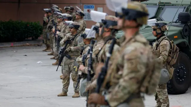 Members of the National Guard stand guard in front of the Federal building in Los Angeles