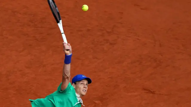 Jannik Sinner serves