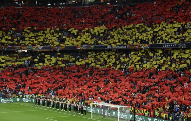 Spain fans display a tifo in the stands before the match