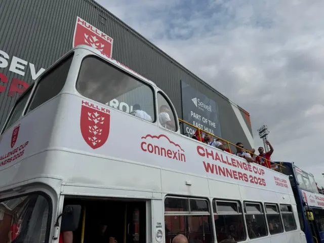 A white open top bus parked outside Craven Park in Hull