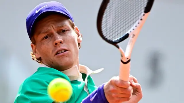 Jannik Sinner plays a forehand return