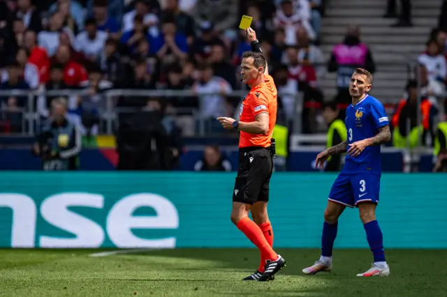 Lucas Digne of France receives the yellow card by referee Ivan Kruzliak