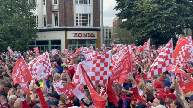 A sea of flags wave in Queen Victoria Square