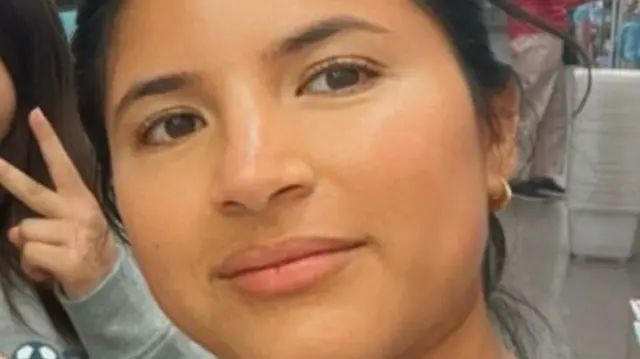 Alex Castellon, 28 wears small gold hoops and has dark hair.