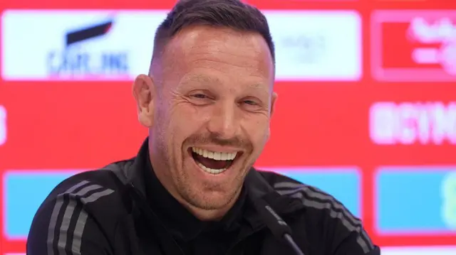 Craig Bellamy smiles during a press conference