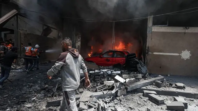 Fire crews tackle a blaze after Israeli forces airstrikes hit residential buildings in Gaza