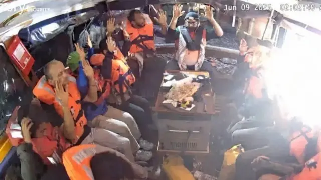 A photo purportedly showing activists with their hands up on board the Madleen ship
