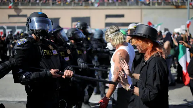 A police officer squares off against a protester during demonstrations in Los Angeles.