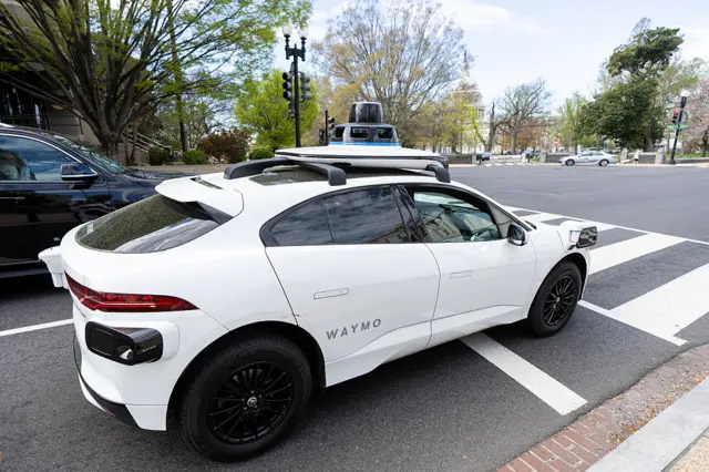 A Waymo self-driving car, seen here with a driver, stops at a red light outside the U.S. Capitol in Washington, D.C., on Friday, 31 March, 2025.