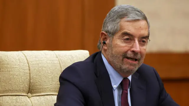 Mexico Foreign Minister Juan Ramon de la Fuente sitting down as he speaks wearing a suit.