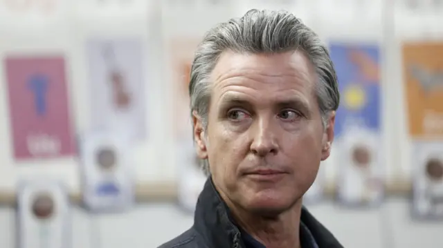 California Governor Gavin Newsom looks away from the camera.