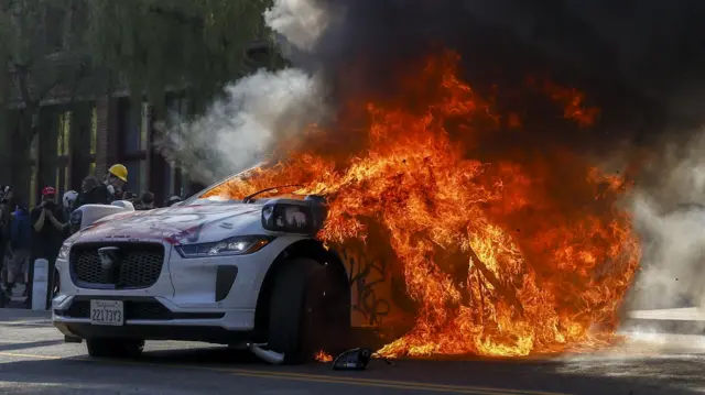 A Waymo self driving car burns as activists protest immigration raids in Los Angeles, California, 8 June 2025.