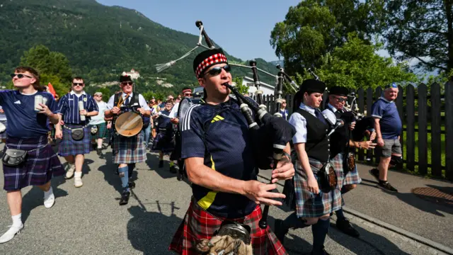Scotland fans march to the stadium ahead of an International Friendly match between Liechtenstein and Scotland at Rheinpark Stadion